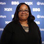 A diverse crowd of people celebrating at a concert, raising their hands and cheering.