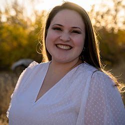 A diverse crowd of people celebrating at a concert, raising their hands and cheering.