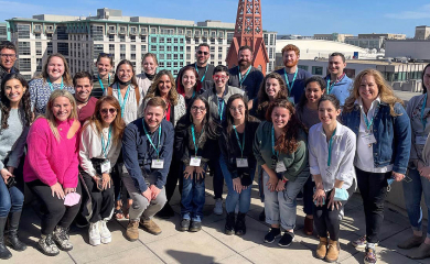 Group of three smiling parents at a community event