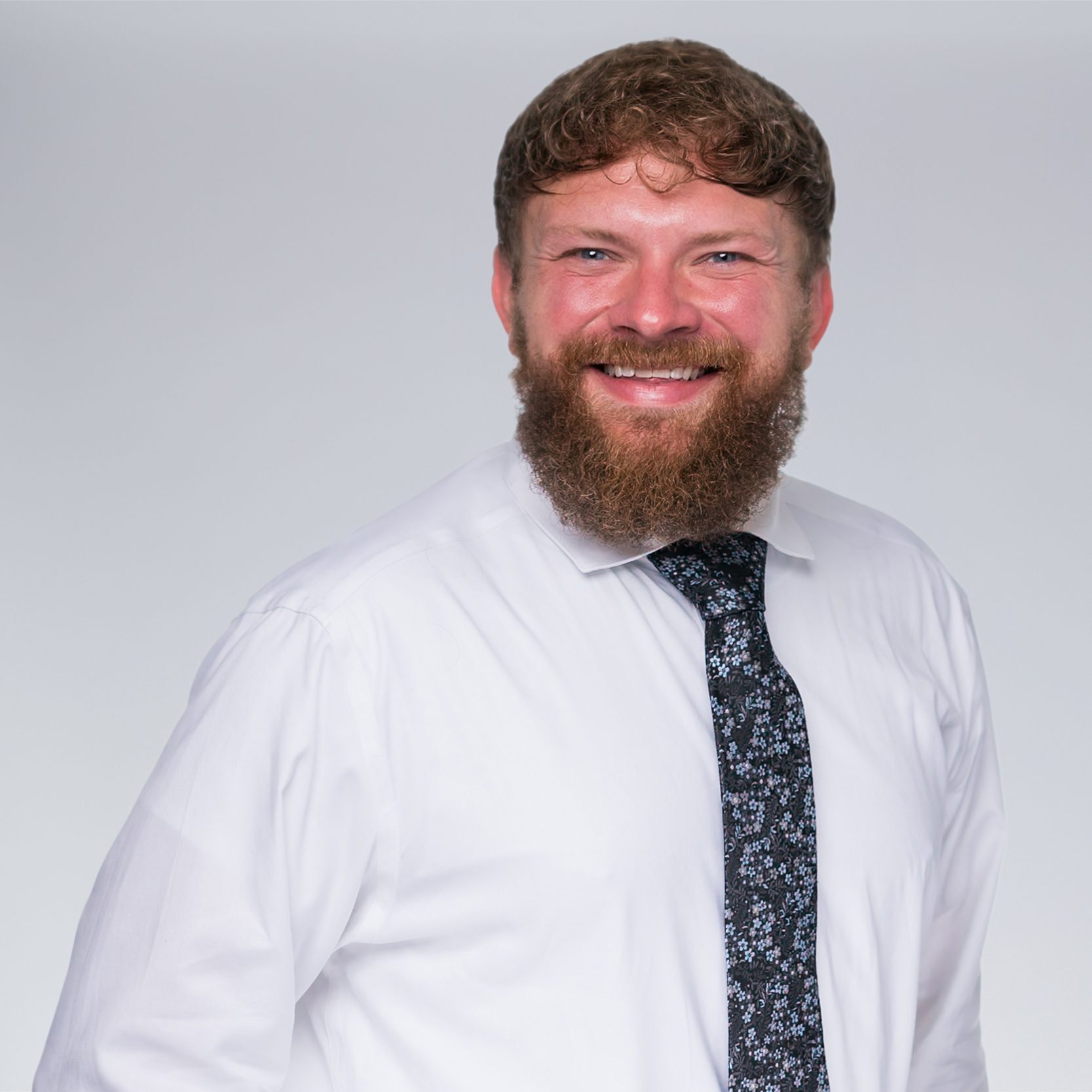 A diverse crowd of people celebrating at a concert, raising their hands and cheering.