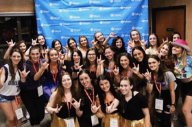 Group of people celebrating on stage